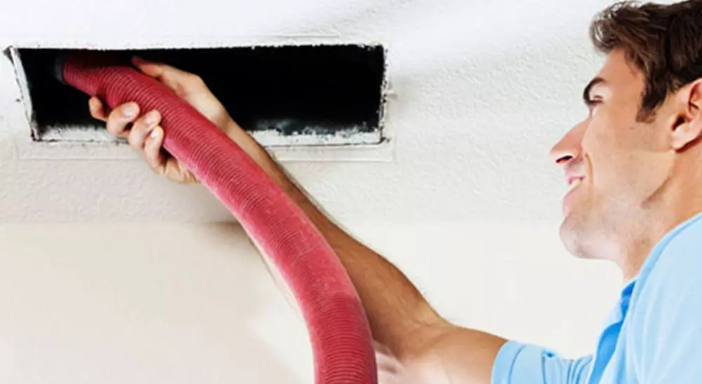 Professional AC duct cleaning technicia