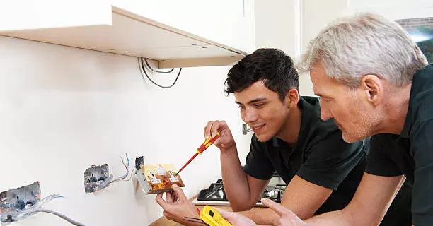 Skilled Technicians Working on Electrical Service Project in Dubai