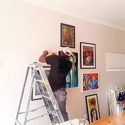 FixitDubai Handymans experts hanging a frame
