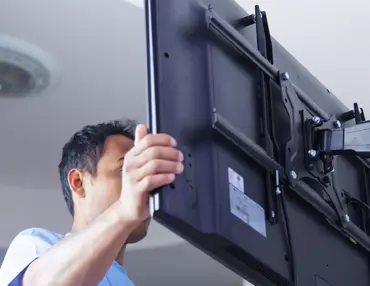 Man Mounting TV on Wall